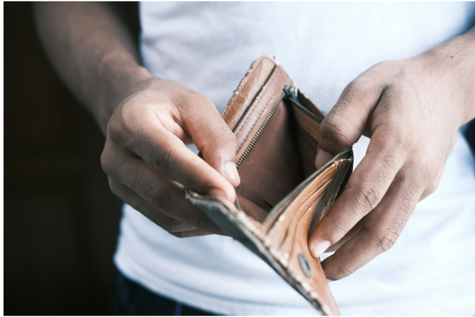 Foto de hombre sosteniendo una billetera vacía en alusión a la necesidad del seguro de desempleo